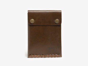 A brown leather wallet with two metal snap buttons on the flap and visible stitching along the bottom edge, standing upright on a white background.