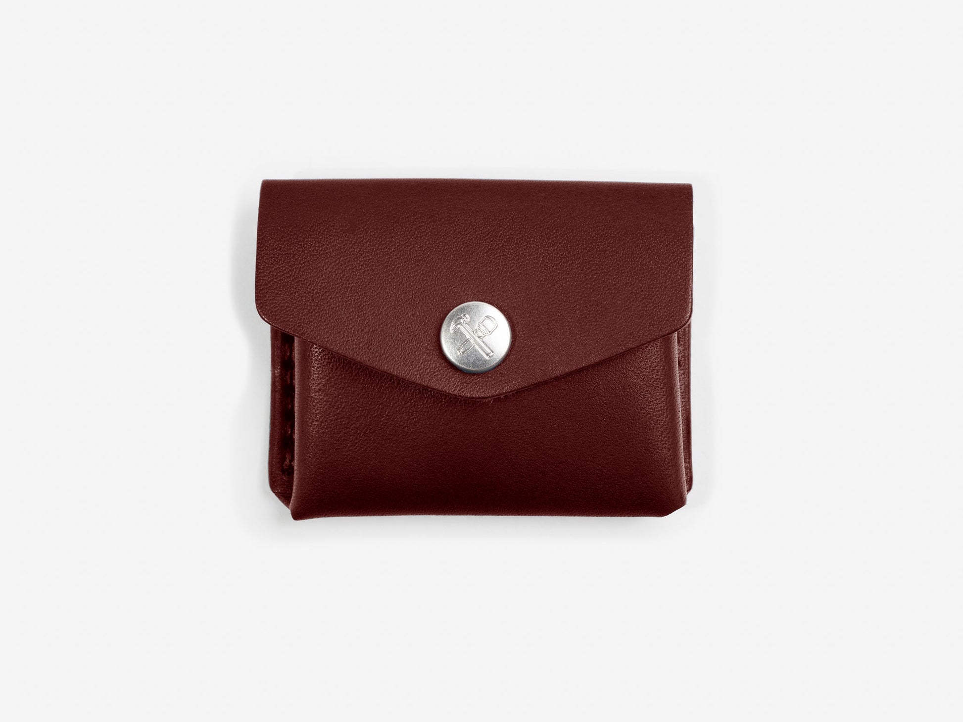 A brown leather coin pouch with nickel-plated snap closure, displayed on off-white background