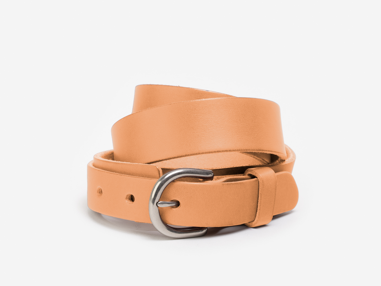 A tan leather belt with a silver buckle, coiled neatly on a white background.