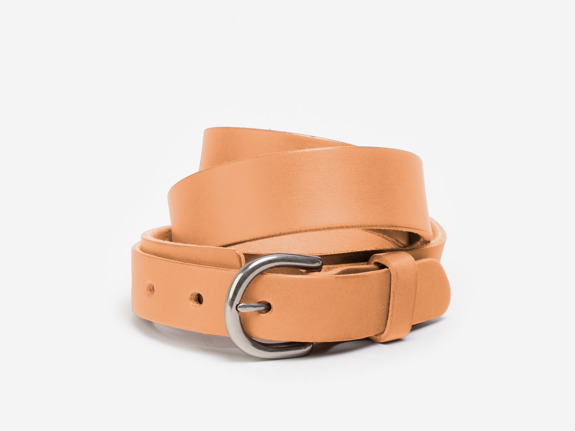 A tan leather belt with a silver buckle, coiled neatly on a white background.