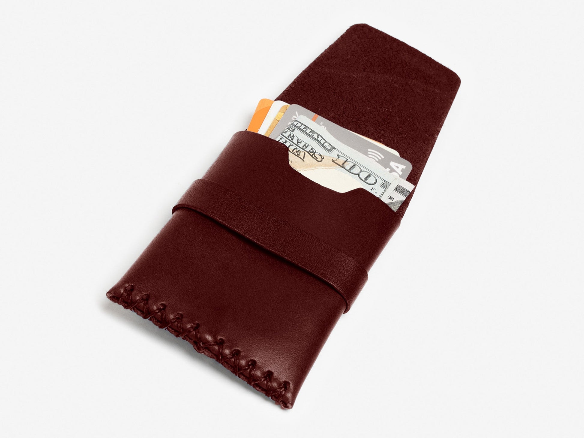A brown leather wallet with stitched edges, partially open to reveal cash and credit cards inside, displayed on a white background.