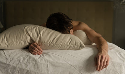 hot dude sleeping on an organic millet hull pillow 