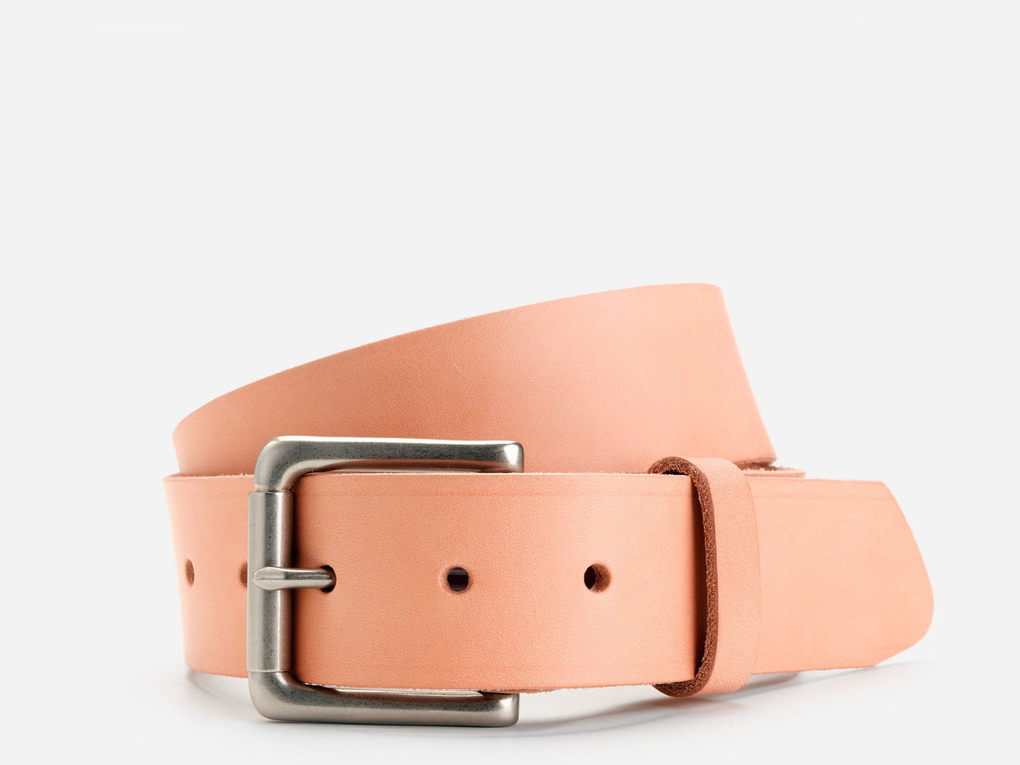 A light tan leather belt with a silver rectangular buckle, coiled neatly on a plain white background.