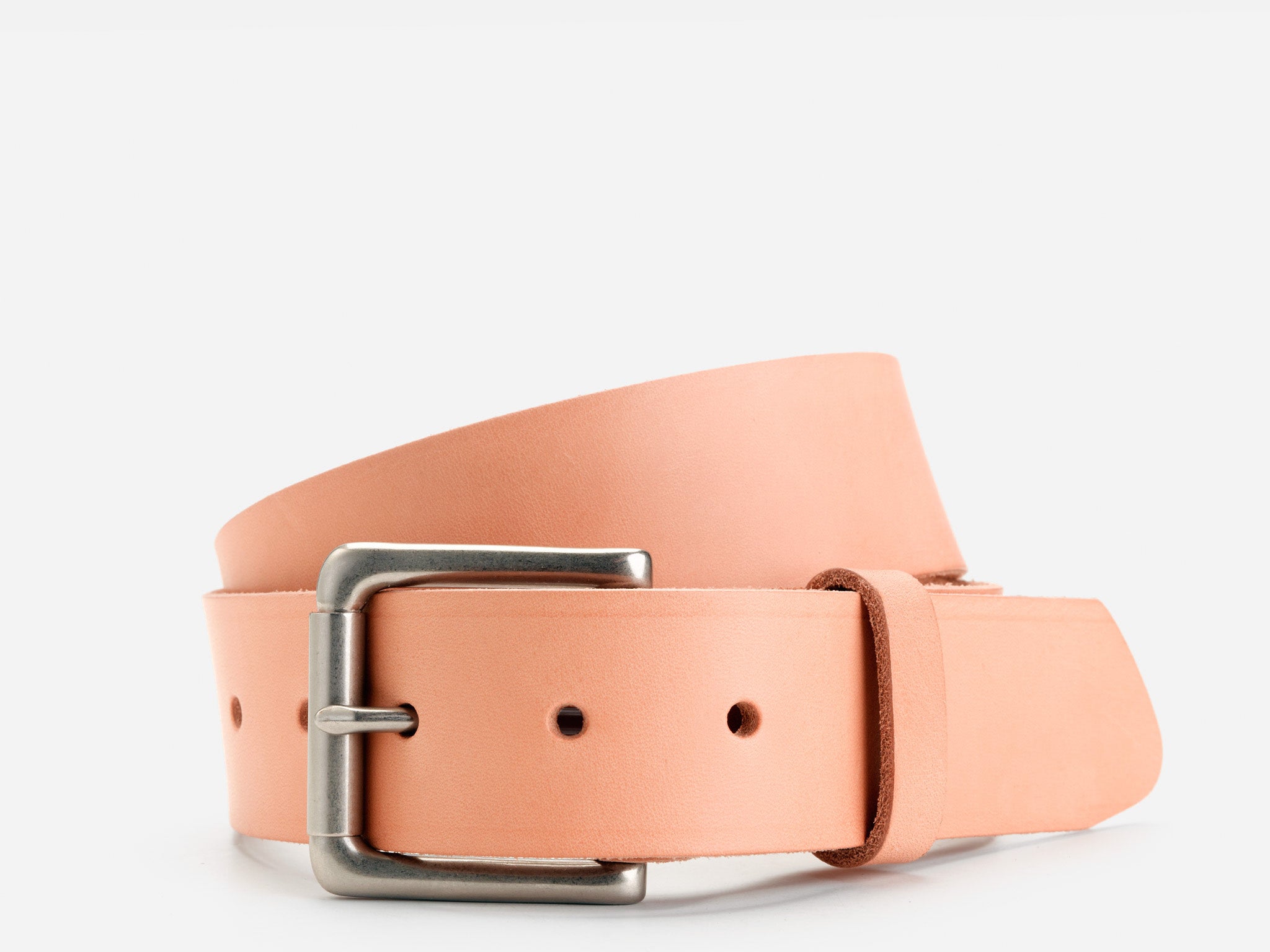 A light tan leather belt with a silver rectangular buckle, coiled neatly on a plain white background.