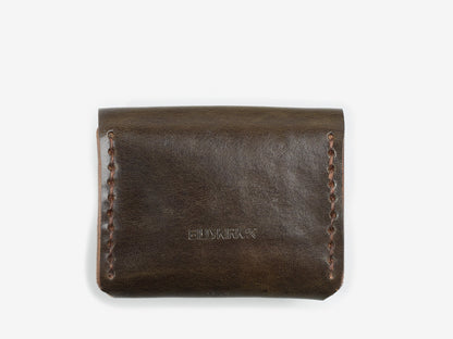 The back of a olive coin pouch with hand-stitched edges with a Billykirk logo embossed at the bottom