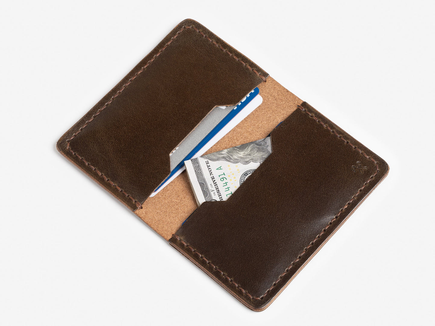 A brown leather wallet open to reveal a blue credit card, a white card, and a folded U.S. twenty-dollar bill against a white background.
