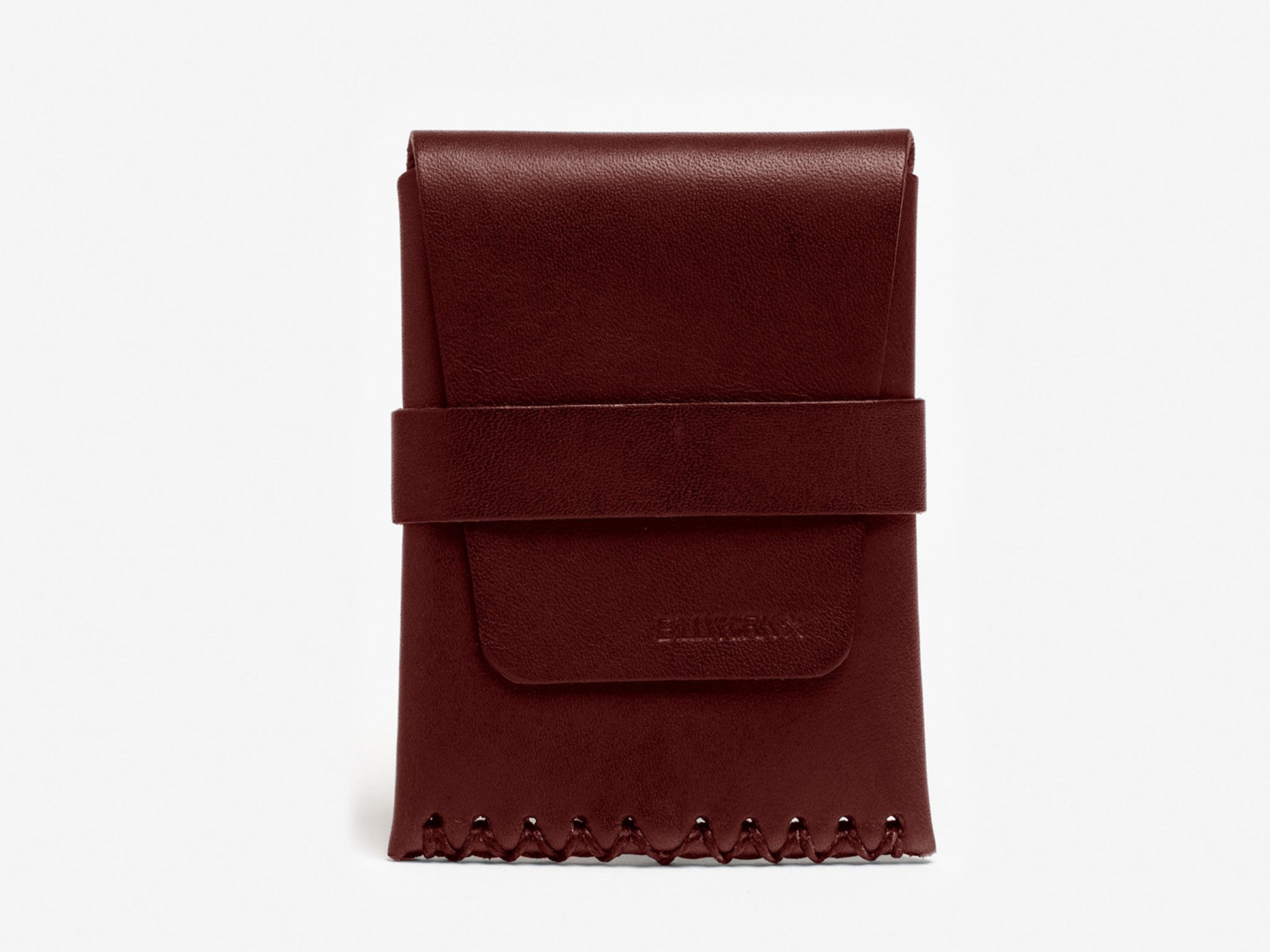 A burgundy leather card case with a flap closure, wide strap across the front, and decorative stitching along the bottom edge, placed against a plain white background.