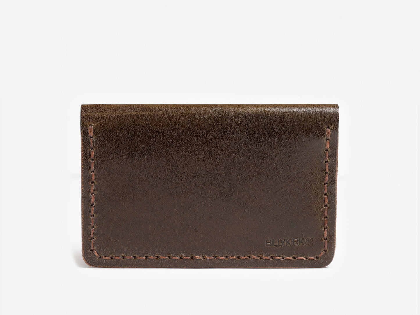 A simple brown leather card holder with visible stitching and the word BILLYKIRK embossed in the lower right corner, displayed against a plain white background.