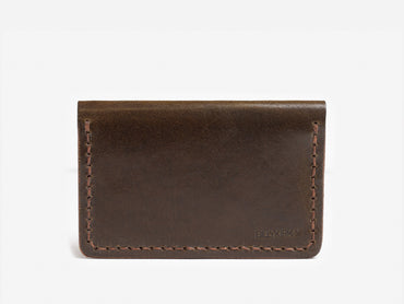A simple brown leather card holder with visible stitching and the word BILLYKIRK embossed in the lower right corner, displayed against a plain white background.
