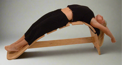 woman backward stretch on whale stretching  bench