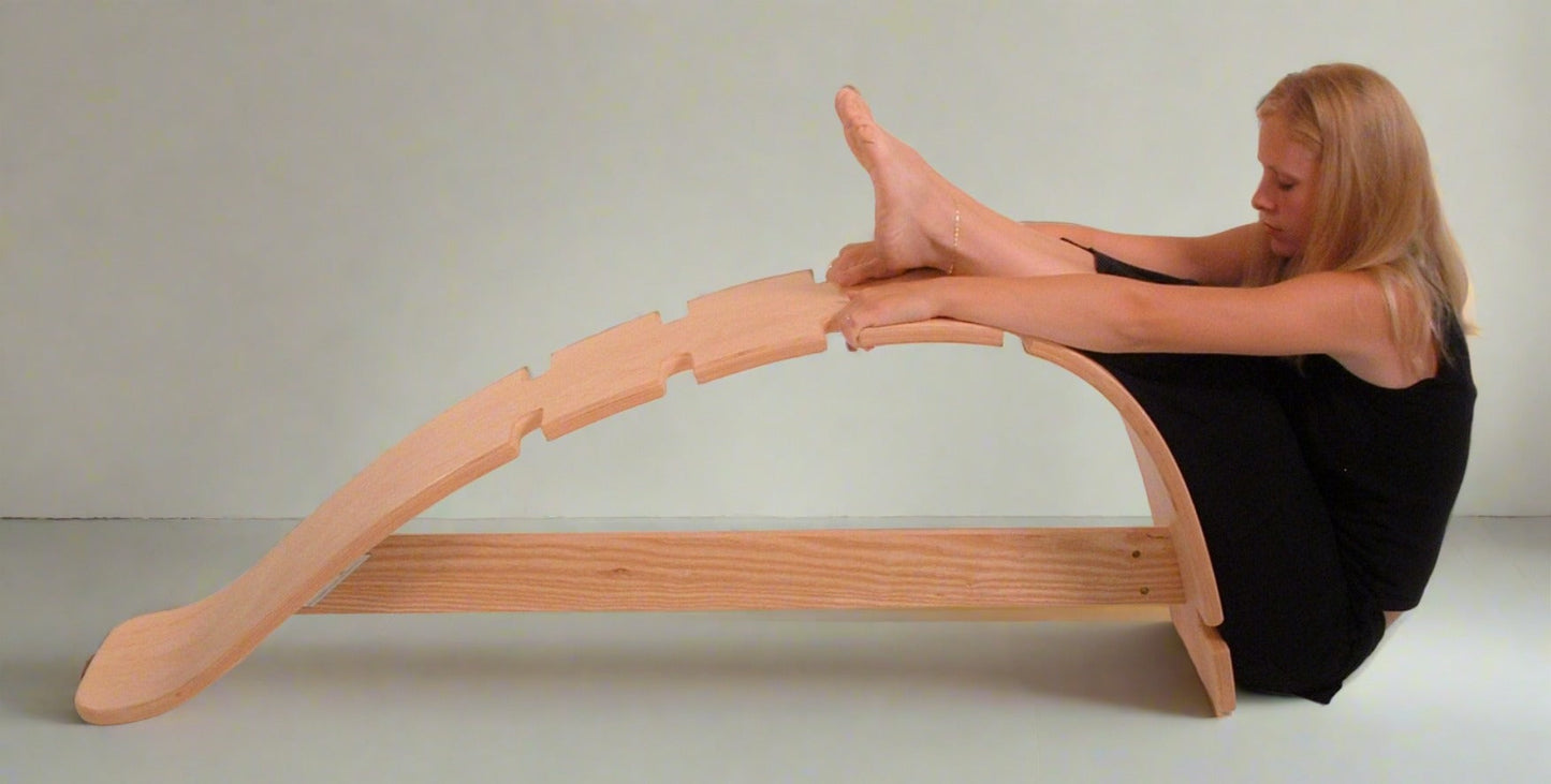 woman hamstring stretch on whale stretching bench