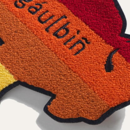 Close up of large Steven Paul Judd designed sew-on buffalo patch in yellow orange and red.