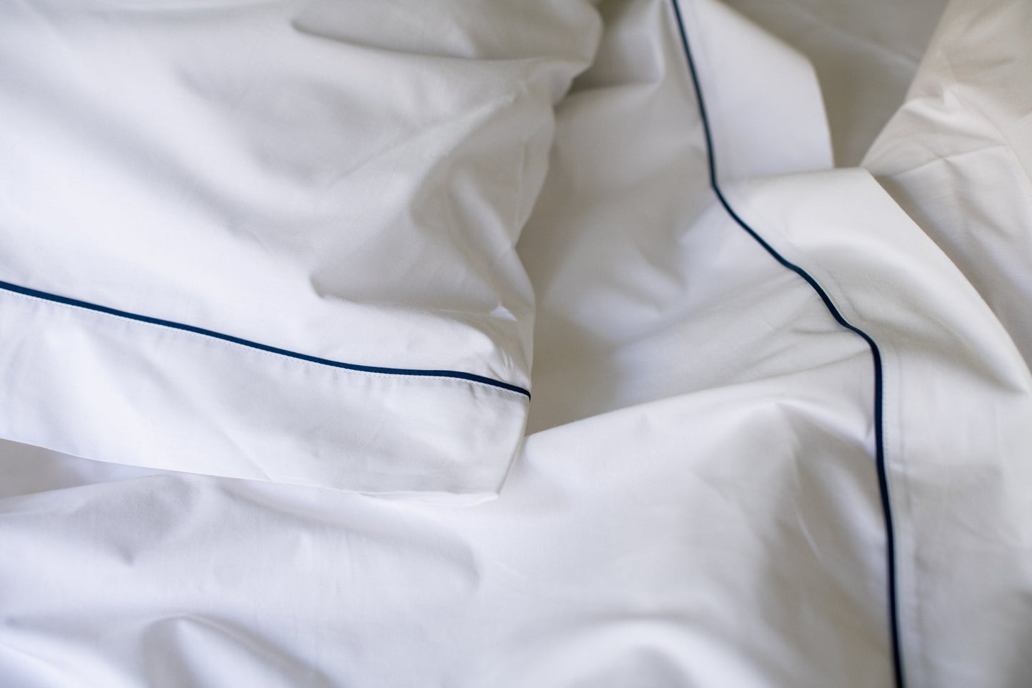 Closeup of Pillowcase and Sheet Hem Navy Blue Bed Sheet Set Classic Piping Design Cotton Made in USA