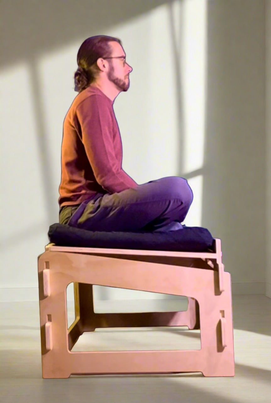 man cross legged sitting on active sitting chair bench