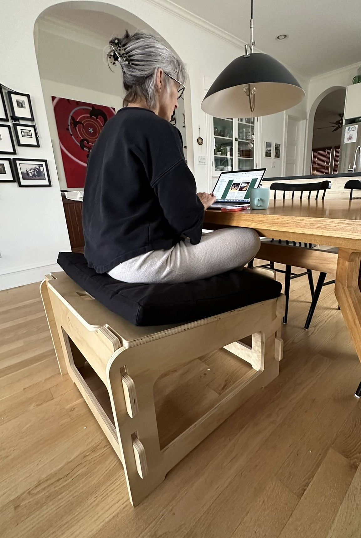 gorgeous woman active sitting cross legged on higher ground sage chair