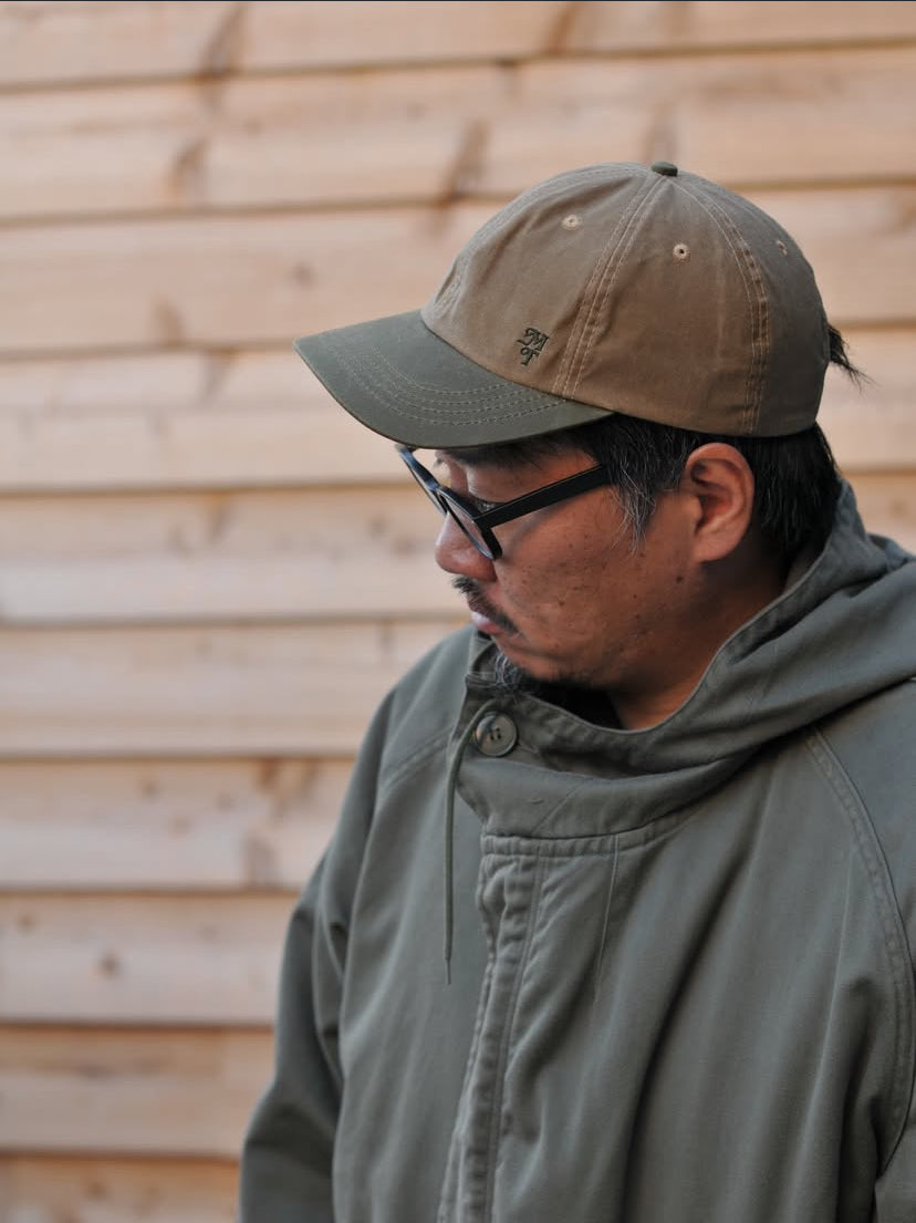 Man wearing waxed brush hat by mad trapper