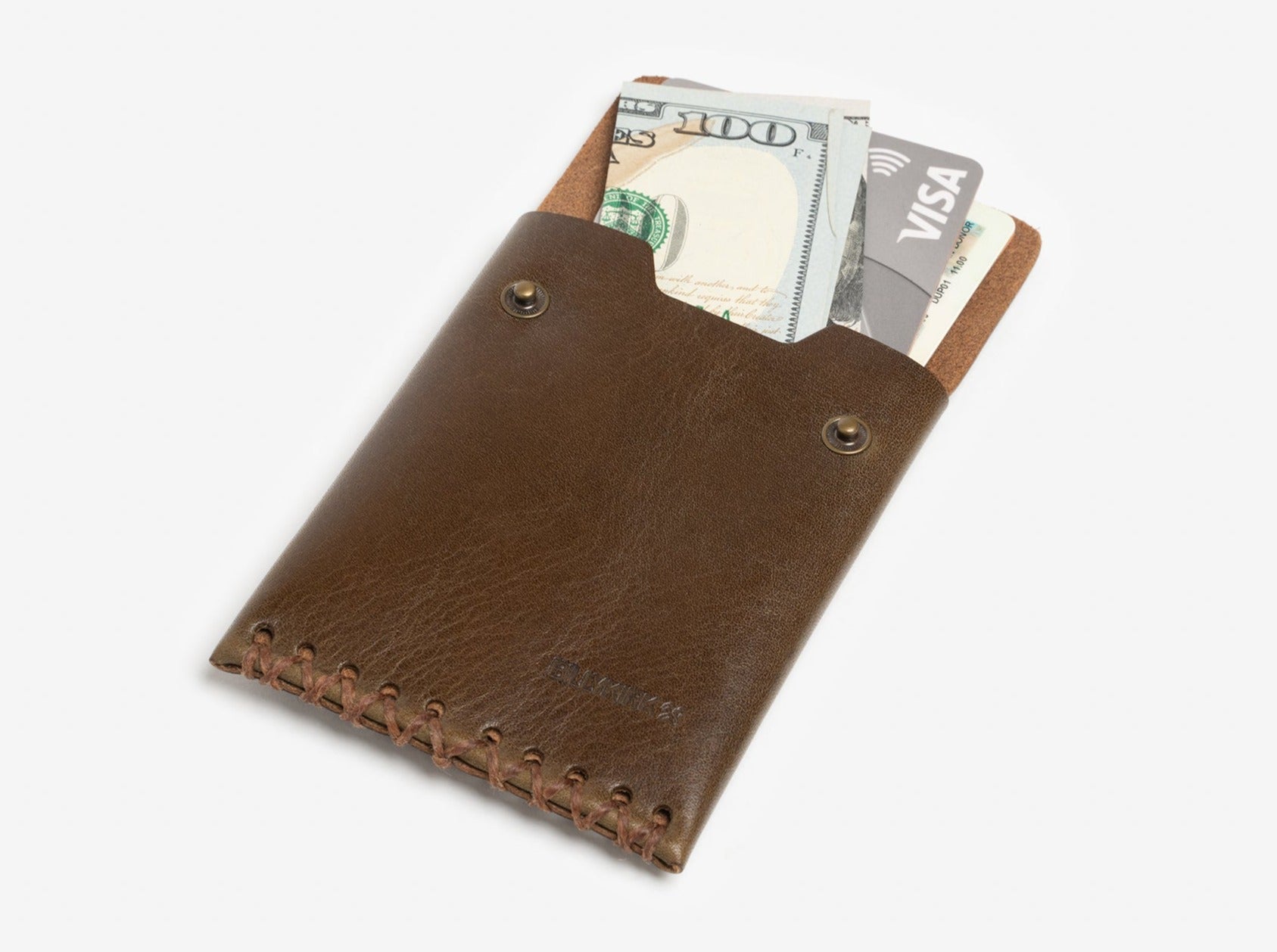 A brown leather wallet with stitching details partially open, revealing U.S. dollar bills and a VISA credit card inside against a plain white background.