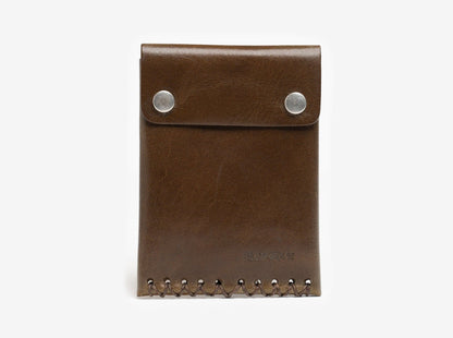 A brown leather wallet with two silver snap buttons on the flap and decorative stitching along the bottom edge, placed against a plain white background.