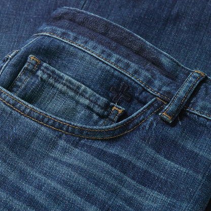 Close up of front right pocket that features a dark navy embroidered cross above the small watch pocket.