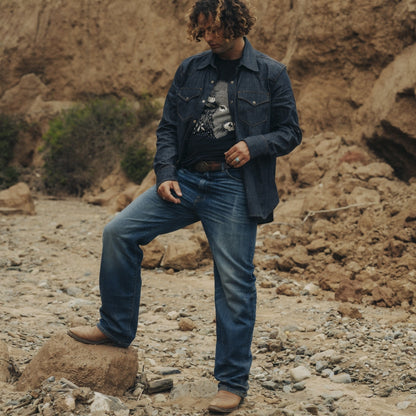 Kurabo denim jeans custom wash on a man wearing a buffalo tshirt in a canyon