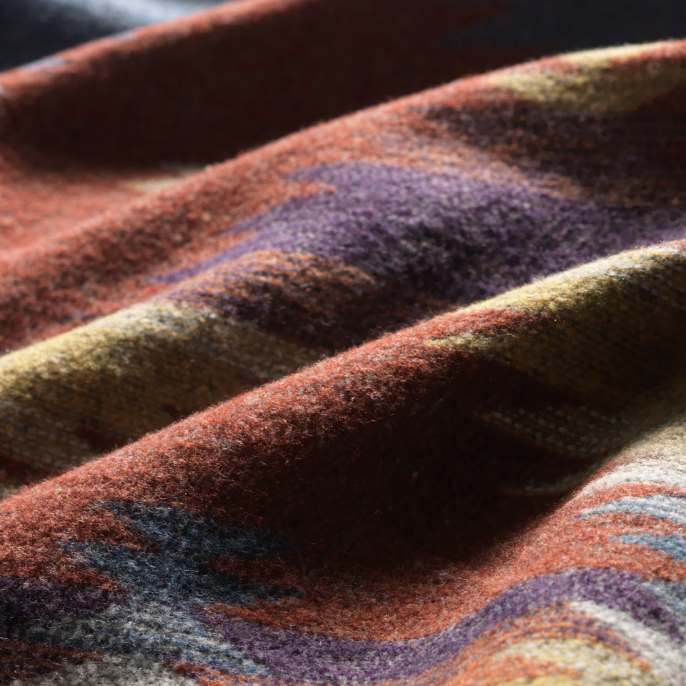 Close up of wool color pattern inside Green Herringbone Coat open to view southwest pattern in orange, blue, yellow and white