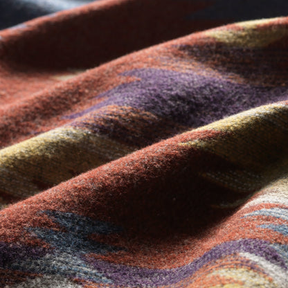 Close up of wool color pattern inside Green Herringbone Coat open to view southwest pattern in orange, blue, yellow and white