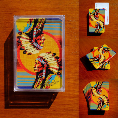 Collage of Steven Paul Judd designed Sitting Bull Playing cards slightly fanned out on wood table 