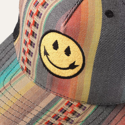 Close up of Native American Steven Paul Judd designed trucker hat with arrowhead smiley face and colorful front panel.