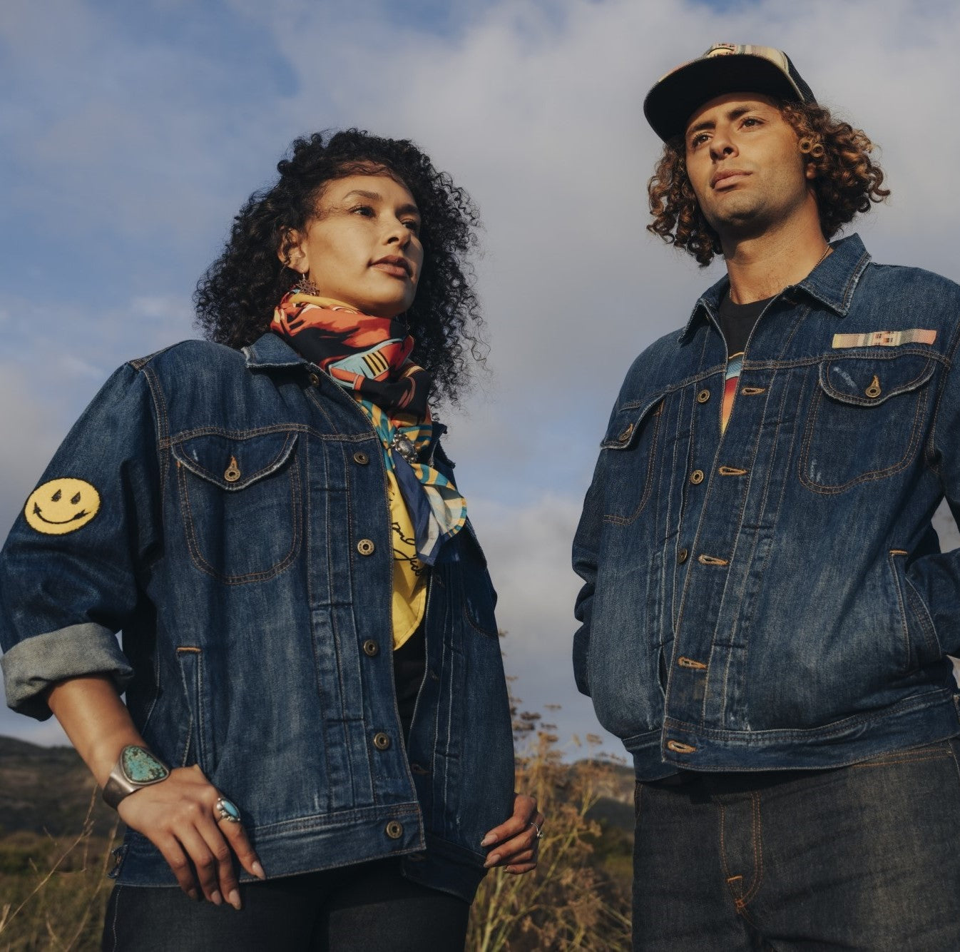 Woman and man wearing distress deadstock denim jacket customized by Steven Paul Judd with Native American designed patches