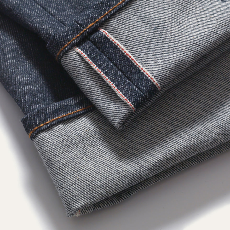 Selvedge Denim jean. View of bottom hem, jean is cuffed exposing inside seam.