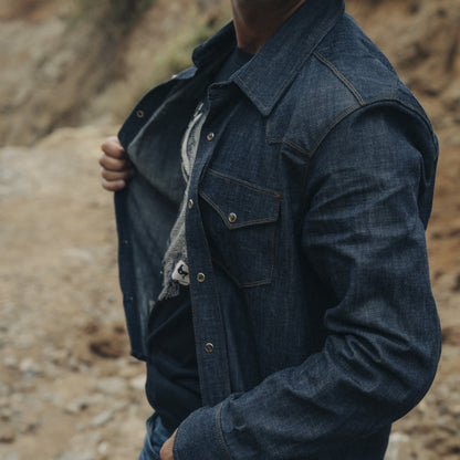 Side view of a chambray cotton western snap shirt on man at canyon