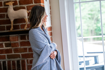 Woman with Blanket Patriot Blue  Folded Blanket Herringbone Weave Cotton Made in USA