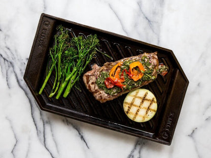 Cast iron grill pan with steak and veggies
