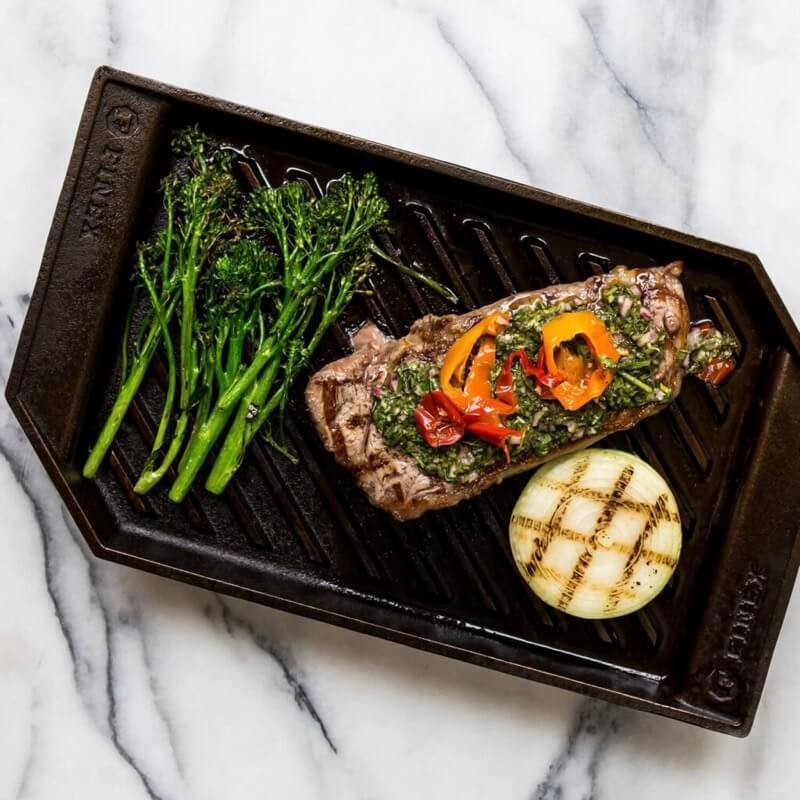Cast iron grill pan with steak and veggies