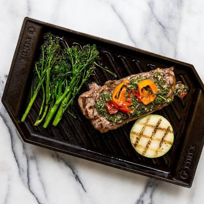 Cast iron grill pan with steak and veggies