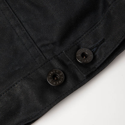 Detail view of custom hardware and adjustable button on back hem.