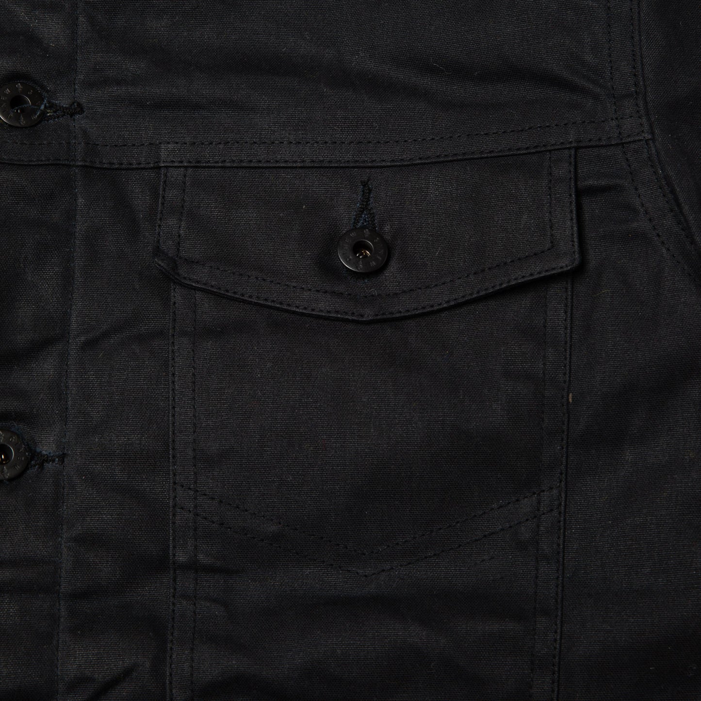 Detail view of front chest pocket on Coat.