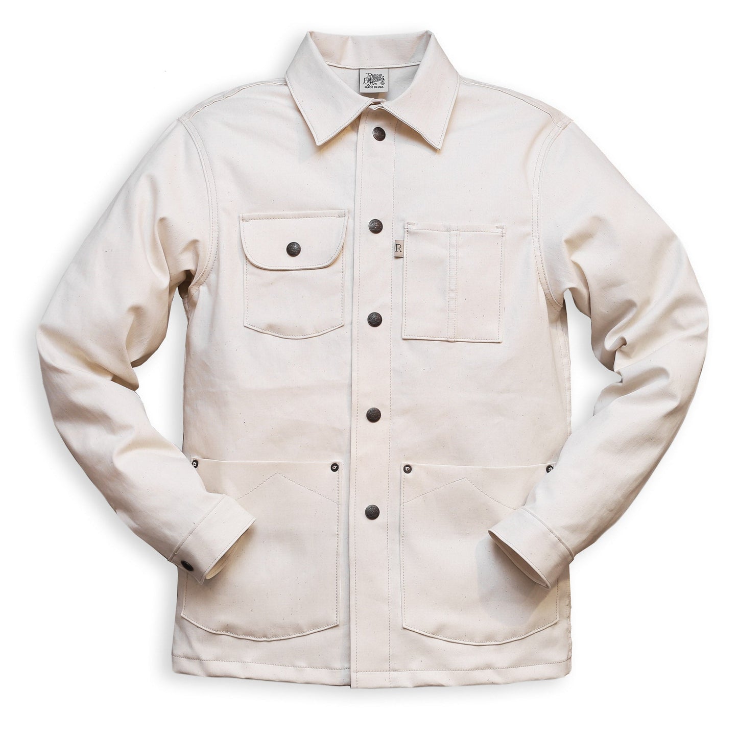 A natural seed chore coat with snap buttons, featuring a collar, front pockets, and long sleeves.