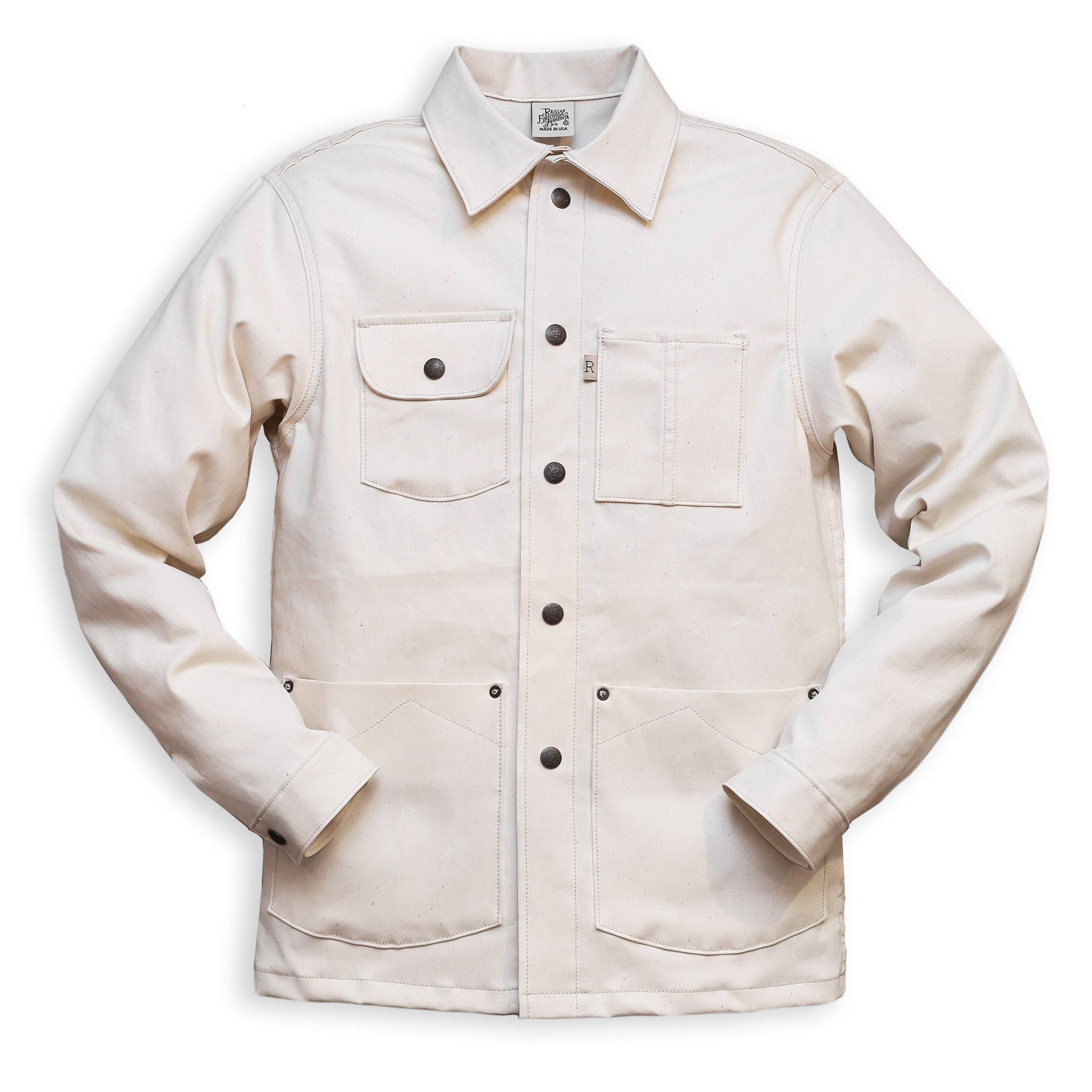 A natural seed chore coat with snap buttons, featuring a collar, front pockets, and long sleeves.